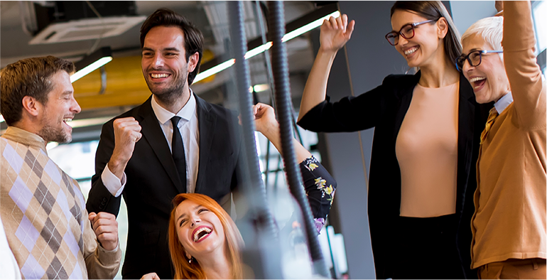 A group of people celebrating in an office during a party.