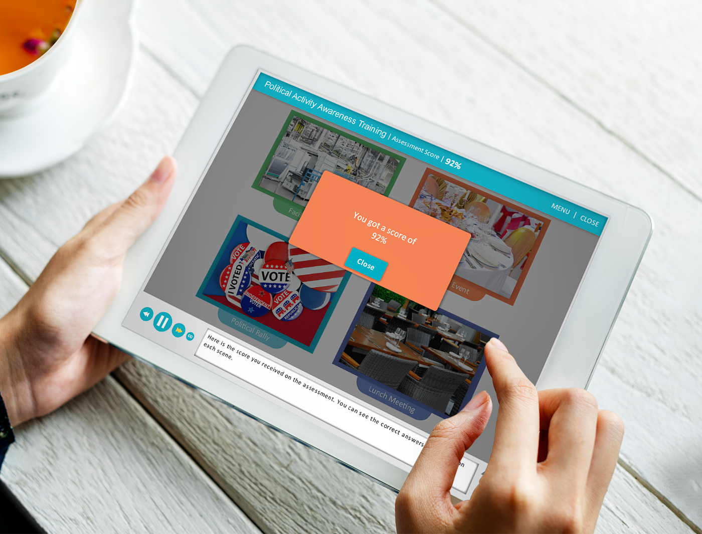 Person holding a tablet displaying a web page with a pop-up advertisement about Lobbying and Political Activity Training.