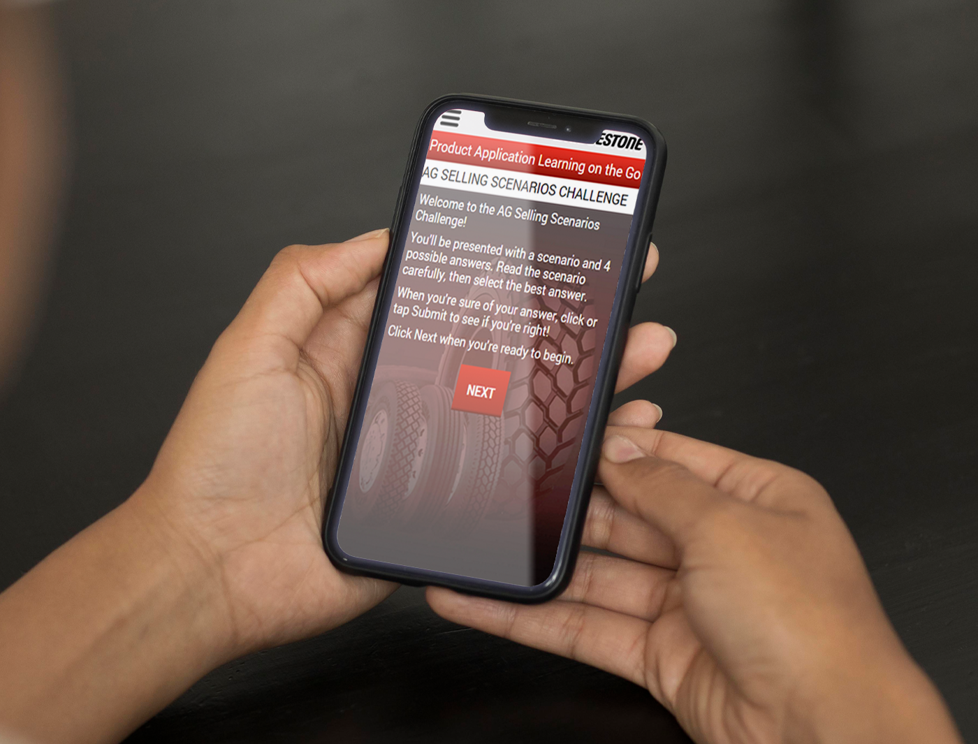 A person holding a smartphone displaying a mobile product application training on the go.