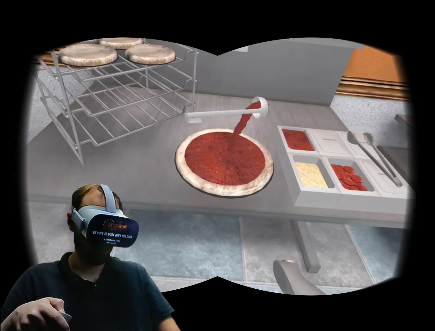Designing Digitally - A person wearing a virtual reality headset interacts with a simulated pizza-making station, preparing a pizza with sauce and various toppings, showcasing the potential of fast food training simulations. Designing Digitally -