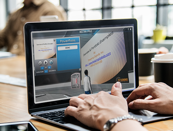 A person editing a technical training PowerPoint presentation on a laptop in an immersive office environment.