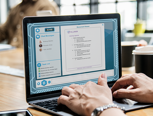 A person working on a laptop displaying a document viewer with chat messages related to cyber security assessment and a task list on the screen.
