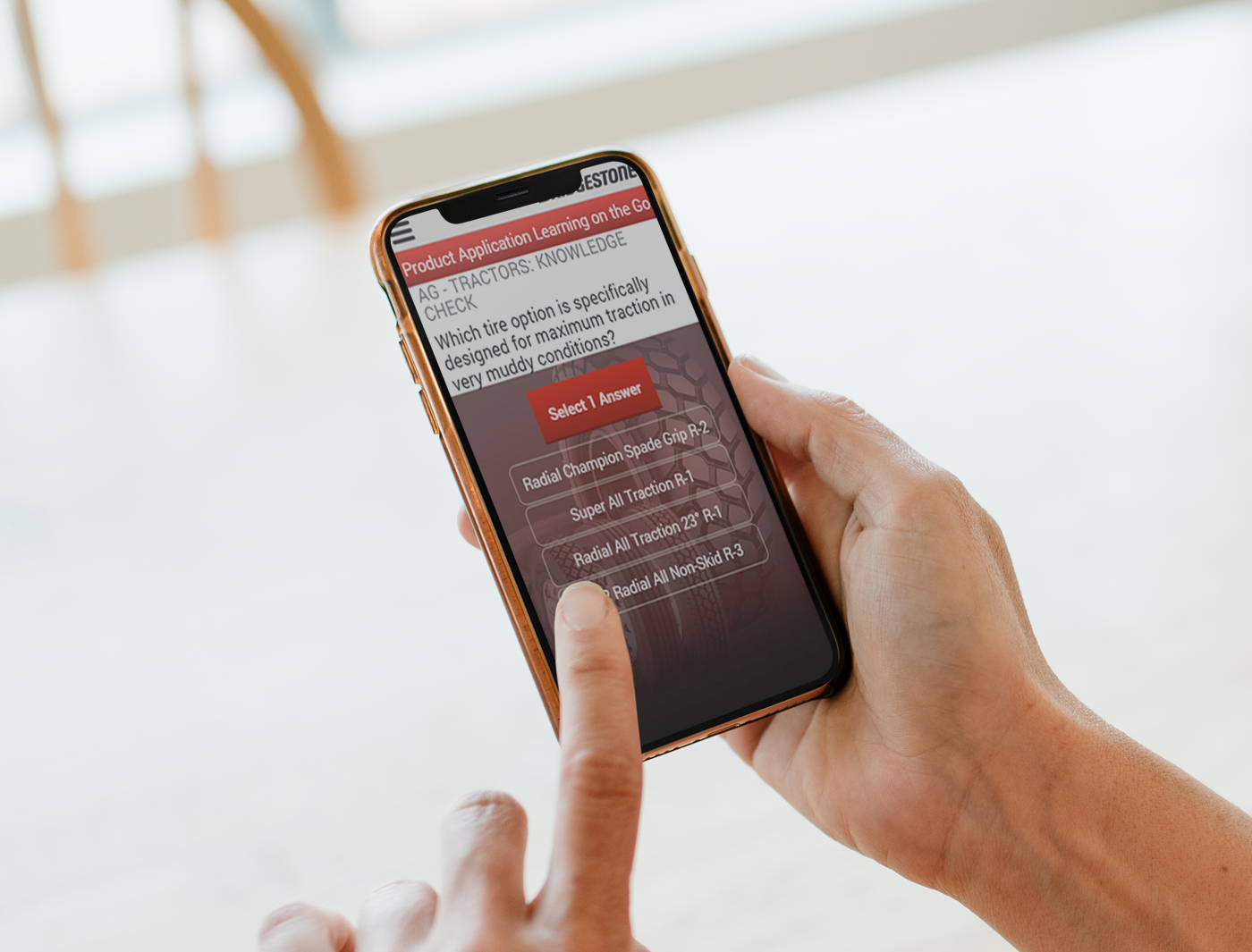 Close-up of a person holding a smartphone displaying a text exchange on the screen through a mobile product application.