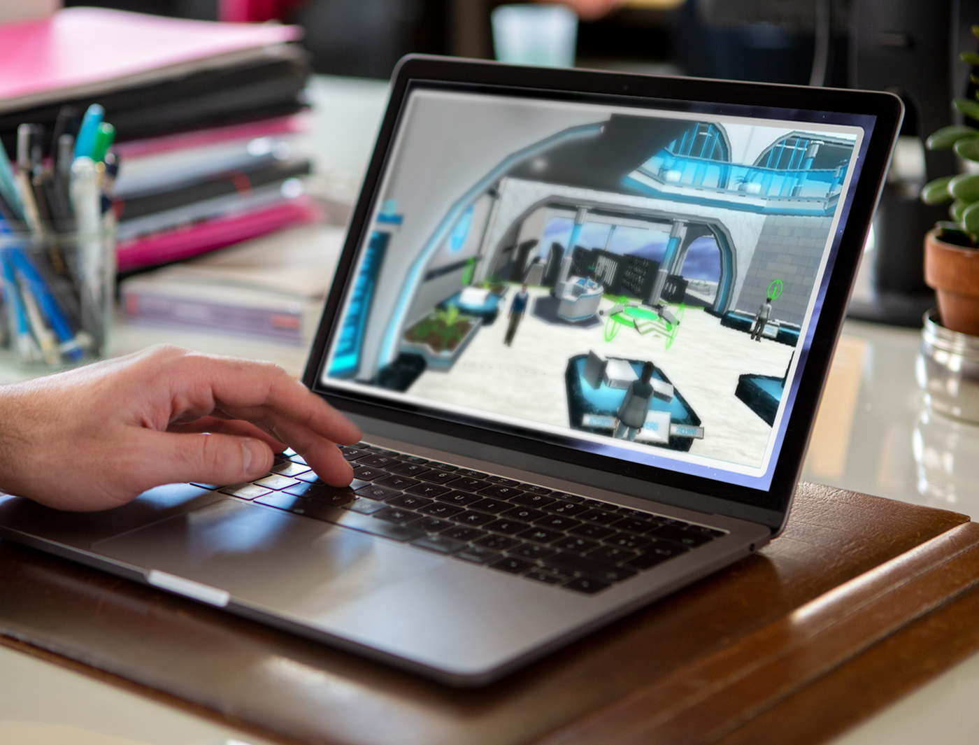 A person's hand using a laptop displaying an immersive 3D interior design model.