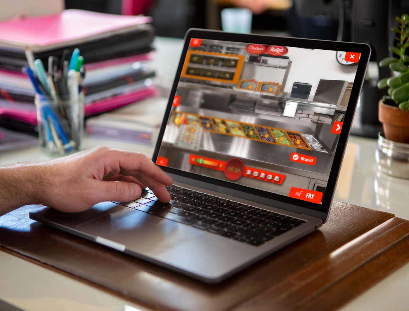 Person placing an online food order on a laptop screen, browsing through custom training games for employees.