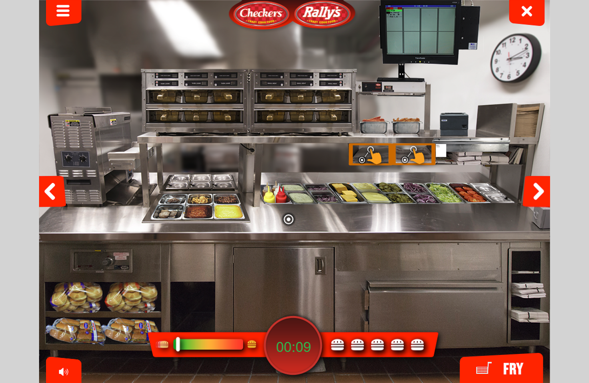 A commercial kitchen setup for a fast-food restaurant with cooking equipment and ingredients on display, designed to incorporate custom training games for employees.