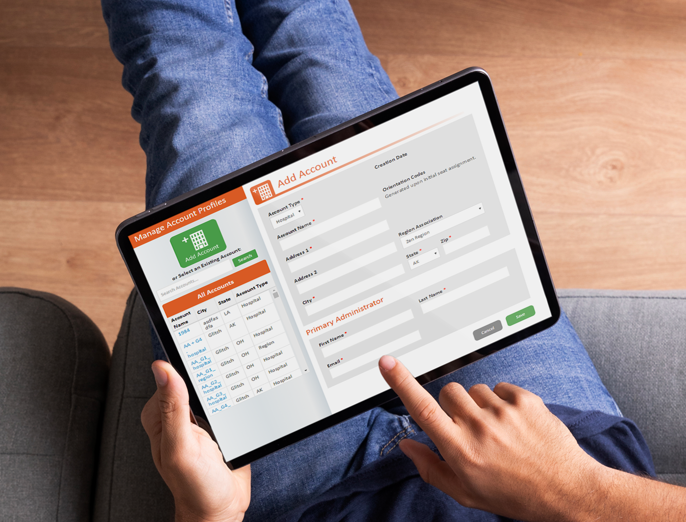 Designing Digitally - A person seated with crossed legs holding a tablet displaying a "Mobile App Vendor" login screen, interacting with it using their right index finger. Designing Digitally -