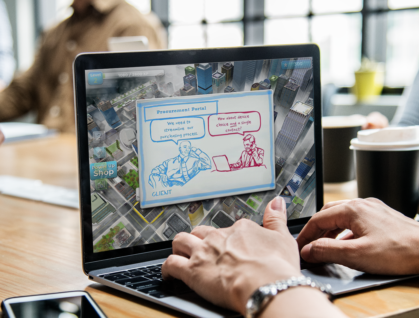Designing Digitally - Hands of a person using a laptop displaying a digital illustration of an eLearning vendor portal conversation between a shop and a client. Designing Digitally -