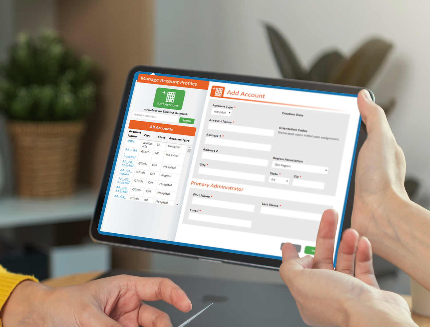 Designing Digitally - Two people holding a tablet displaying an account management form with fields for account details and account profiles, which also includes options related to the Hazardous Material Training Program. Designing Digitally -