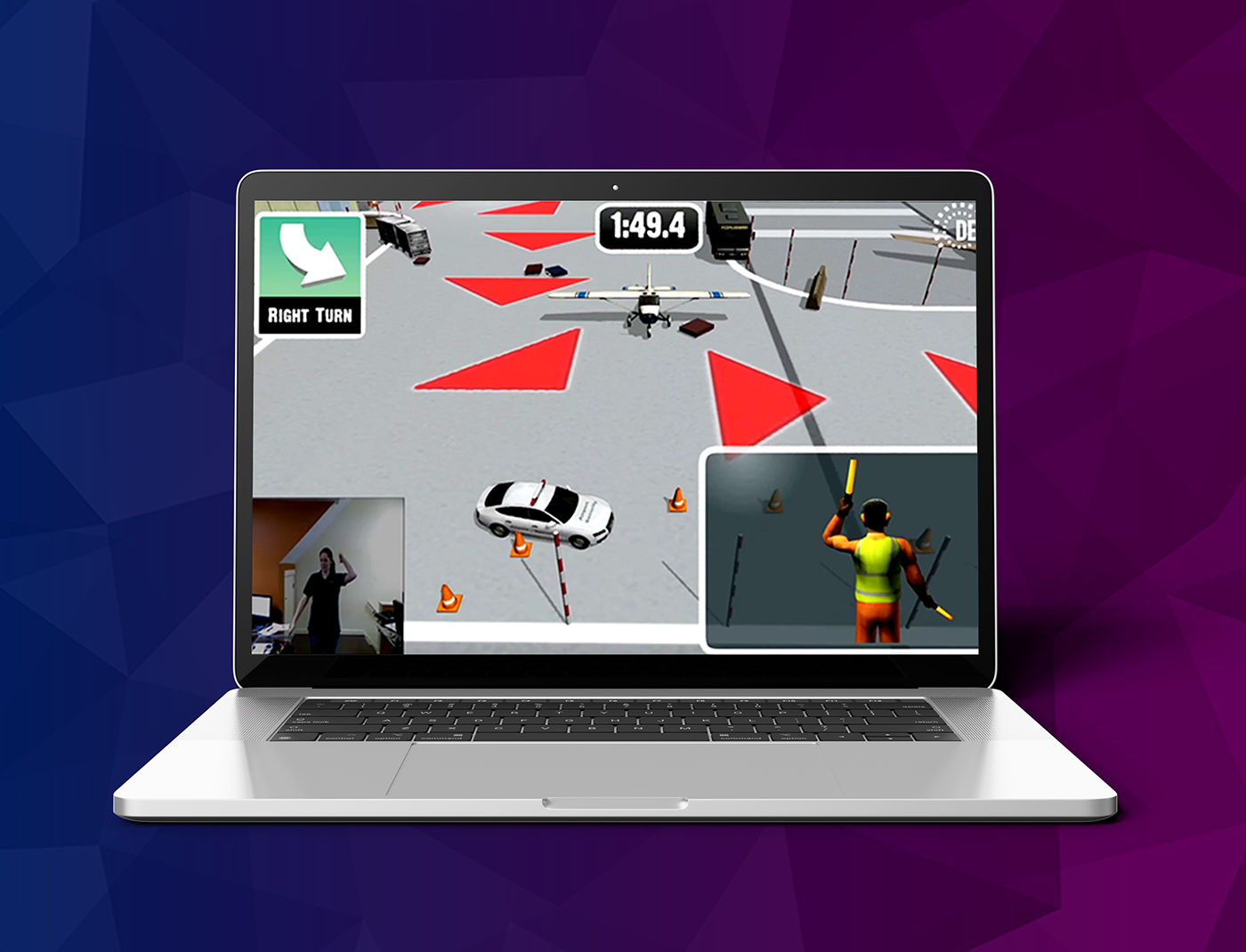 Designing Digitally - A laptop screen displays a driving simulation game with directional arrows and a countdown timer. There is a smaller video feed showing a person gesturing, likely controlling the game through motion tracking, making it an innovative training game experience. Designing Digitally -