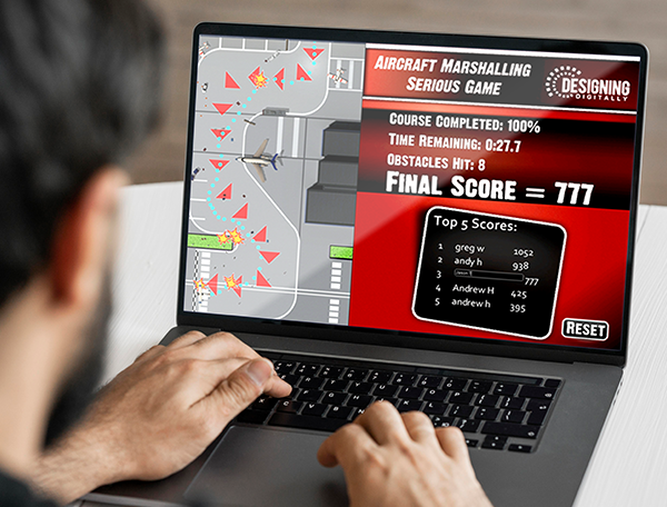 Designing Digitally - Person playing an aircraft marshalling game on a laptop, using motion tracking for a more immersive experience. The screen shows a completed course, final score of 777, and a leaderboard with scores under the "Top 5 Scores" section. Designing Digitally -
