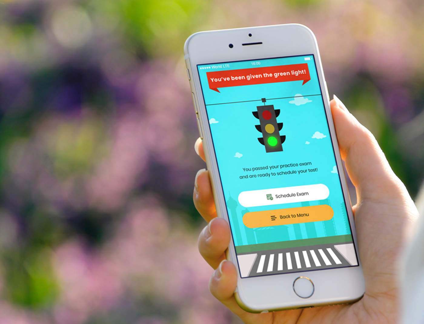 A person using a mobile application with a traffic light app for drivers education.