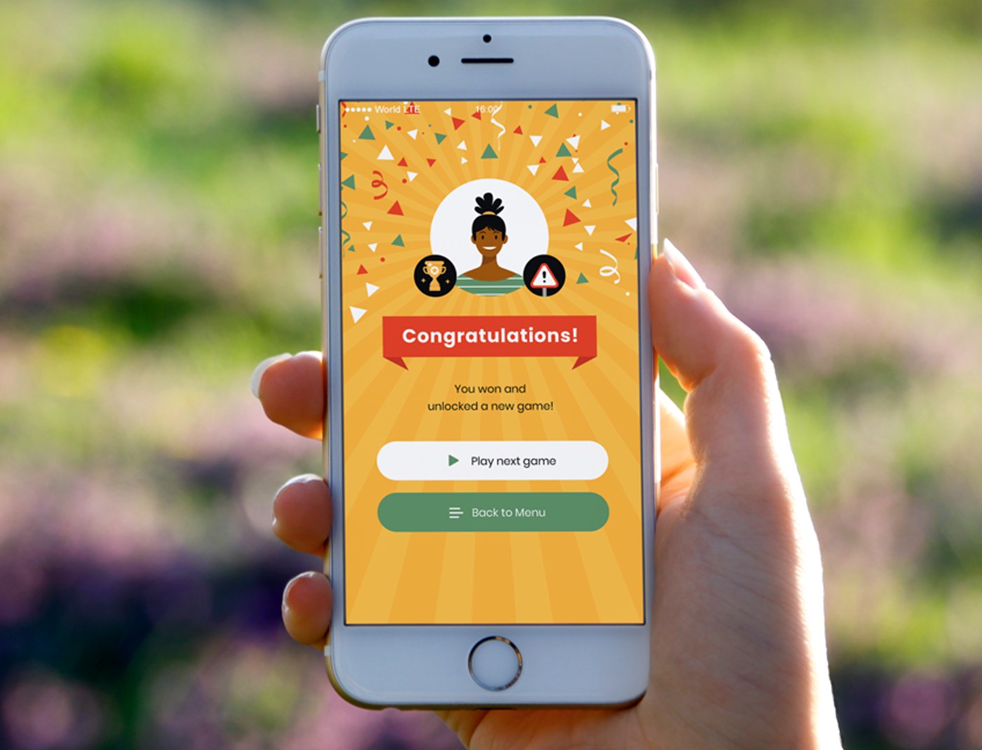 A person holding up a mobile application with a congratulations message on it.