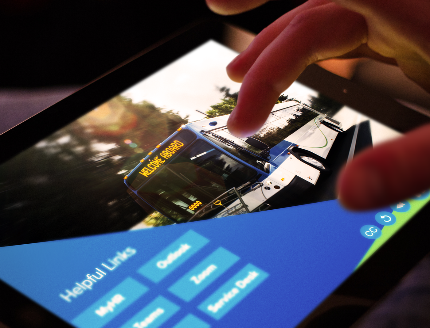 A person participating in a Compliance Training Program, holding a tablet with a picture of a bus on it.
