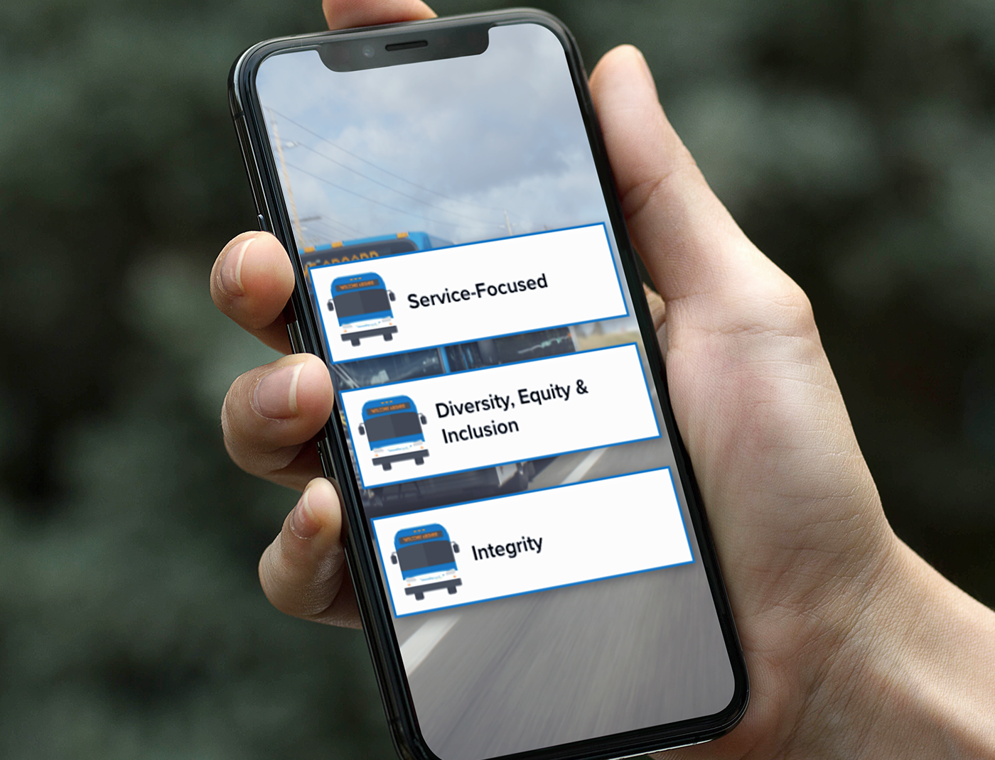 A person holding a cell phone with a truck on it as part of their Compliance Training Program.