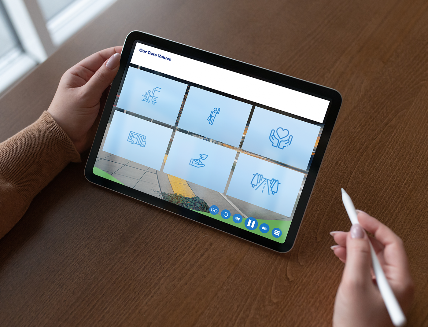 A person participating in a Compliance Training Program holds a tablet.