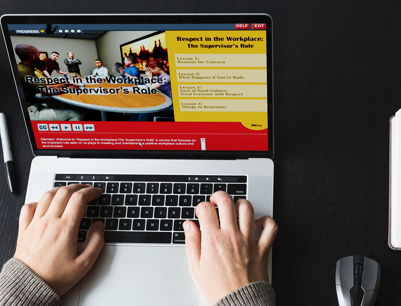 Designing Digitally - Hands typing on a laptop displaying a training module titled "Respect in the Workplace: The Supervisor's Role," with lessons on reasons for concern, types of behavior, and managing a culture of civility at Comcast. Designing Digitally -