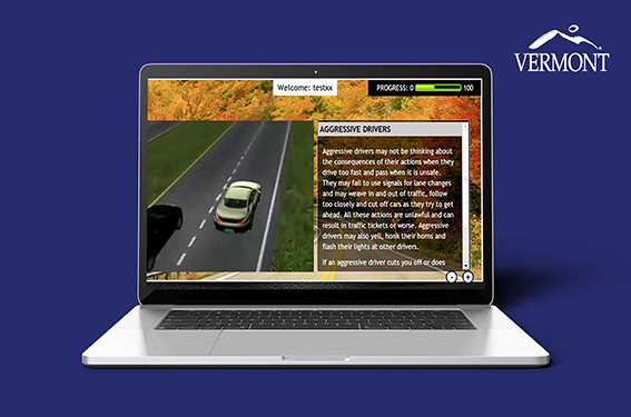 An image of a laptop screen showing a car driving on a blue background for online Drivers Education Training.