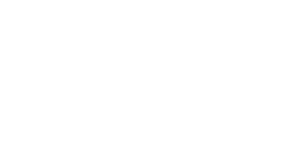 Designing Digitally - White logo of Johns Hopkins University featuring a shield with symbols and text below, denoting its excellence in medical education programs like Trauma Nurse Training Simulations, on a transparent background. Designing Digitally -