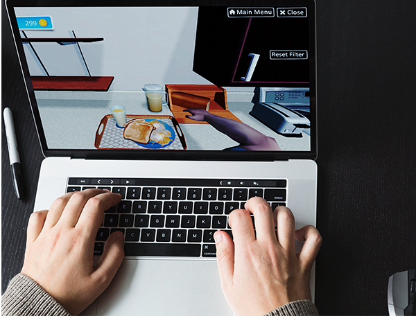 An occupational therapy simulation where a person is utilizing a laptop for typing exercises.