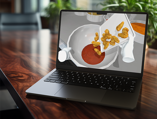 Designing Digitally - A laptop on a wooden table displays a screen showing a 3D rendering of food being poured into a bowl, part of an advanced virtual reality simulation for food preparation training. Designing Digitally -