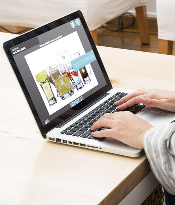Designing Digitally - A person is typing on a laptop, immersed in an educational graphic about different beverages. The screen, designed by a custom eLearning solutions vendor, showcases detailed insights and interactive elements to enhance the learning experience. Designing Digitally -
